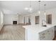 Open floor plan with kitchen island, hardwood floors, and a fireplace at 441 Pine Way, Dallas, GA 30157