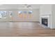 Bright living room with hardwood floors, fireplace, and multiple windows at 441 Pine Way, Dallas, GA 30157