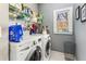 Well-organized laundry room features modern washer/dryer, shelving, and natural light from a window at 1324 Cambridge Ave, Atlanta, GA 30344