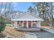 Charming single-story home featuring a cozy front porch and a red front door at 3160 New Macland Rd, Powder Springs, GA 30127