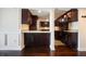 Modern kitchen features dark wood cabinets, granite countertops, and stainless steel appliances at 2870 Pharr Court South Nw # 1205, Atlanta, GA 30305