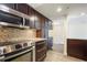 Modern kitchen with stainless steel appliances and tile backsplash at 2870 Pharr Court South Nw # 1205, Atlanta, GA 30305