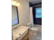 Modern bathroom with navy tile and updated vanity at 312 W Downing Ct, Jonesboro, GA 30238