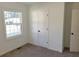 Spacious bedroom with large window and closet at 312 W Downing Ct, Jonesboro, GA 30238