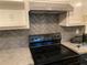 Modern electric range with updated backsplash at 312 W Downing Ct, Jonesboro, GA 30238