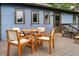 Wooden deck with small table and chairs, view of blue house at 120 Howard Se St, Atlanta, GA 30317
