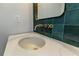Modern bathroom sink with gold faucet and green tile backsplash at 120 Howard Se St, Atlanta, GA 30317