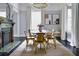 Elegant dining room with a round table, modern chandelier, and a decorative fireplace at 120 Howard Se St, Atlanta, GA 30317