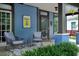 Front porch with seating area and yellow number sign at 120 Howard Se St, Atlanta, GA 30317