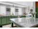 Charming kitchen featuring green cabinets, marble countertops, and stainless steel appliances at 120 Howard Se St, Atlanta, GA 30317