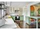 Modern kitchen with green and white cabinetry, stainless steel appliances, and a cozy breakfast bar at 120 Howard Se St, Atlanta, GA 30317