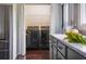 Modern laundry room with washer, dryer, and kitchen view at 120 Howard Se St, Atlanta, GA 30317