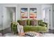 Comfortable living room with a stylish green sofa, modern decor, and ample natural light at 120 Howard Se St, Atlanta, GA 30317
