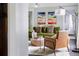 Bright living room featuring a green sofa, colorful artwork, and dark wood floors at 120 Howard Se St, Atlanta, GA 30317