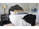 Relaxing bedroom with a decorative headboard, stylish lamps, and minimalist decor at 120 Howard Se St, Atlanta, GA 30317