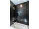 Modern shower with black tile and gold fixtures at 120 Howard Se St, Atlanta, GA 30317