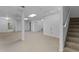 Open basement area with neutral carpeting and access to other rooms at 234 Hampton Shores Dr, Hampton, GA 30228