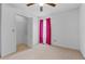 Bedroom with ceiling fan, closet, and pink curtains at 234 Hampton Shores Dr, Hampton, GA 30228