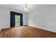 Bright bedroom with wood-look floors and a large window at 234 Hampton Shores Dr, Hampton, GA 30228