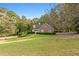 Brick house with landscaped lawn and driveway at 234 Hampton Shores Dr, Hampton, GA 30228