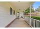 Inviting front porch with white railings and access to the front door at 234 Hampton Shores Dr, Hampton, GA 30228