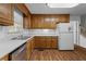 Kitchen with wood cabinets, white appliances, and a window at 234 Hampton Shores Dr, Hampton, GA 30228