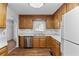 Galley kitchen with oak cabinets, stainless steel appliances, and light countertops at 234 Hampton Shores Dr, Hampton, GA 30228