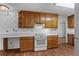 Kitchen with wood cabinets and white appliances at 234 Hampton Shores Dr, Hampton, GA 30228