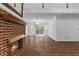 Cozy living room featuring a brick fireplace and hardwood floors at 234 Hampton Shores Dr, Hampton, GA 30228