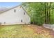 Side yard with a white picket fence and large trees at 234 Hampton Shores Dr, Hampton, GA 30228