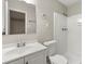 Clean bathroom with white vanity, toilet and shower at 5533 N Wind Sw Dr, Lilburn, GA 30047