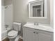 Clean bathroom with white vanity and a large mirror at 5533 N Wind Sw Dr, Lilburn, GA 30047