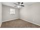 Simple bedroom with neutral walls and carpeting at 5533 N Wind Sw Dr, Lilburn, GA 30047