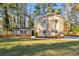 Brick house with a well-maintained lawn and wooden fence at 5533 N Wind Sw Dr, Lilburn, GA 30047