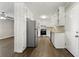 Modern kitchen with white cabinets, granite countertops, and stainless steel appliances at 5533 N Wind Sw Dr, Lilburn, GA 30047