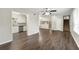 Open concept living room with kitchen view and hardwood floors at 5533 N Wind Sw Dr, Lilburn, GA 30047