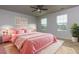 Spacious bedroom with pink bedding and ceiling fan at 816 Royal Red Ct, Mcdonough, GA 30253