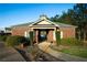 Community clubhouse with brick exterior, manicured shrubs, and covered entrance for neighborhood residents' use at 816 Royal Red Ct, Mcdonough, GA 30253