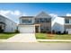 Charming two-story home with brick accents, light blue siding, lush lawn, and two car garage at 816 Royal Red Ct, Mcdonough, GA 30253
