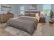 Main bedroom with a king-size bed, neutral decor and ample natural light at 816 Royal Red Ct, Mcdonough, GA 30253