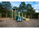 Community playground with slide, climbing structures and safe, mulch ground cover in a wooded community area at 816 Royal Red Ct, Mcdonough, GA 30253
