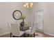 Bright dining room with glass table and chairs, near sliding door at 237 Epping St # 89, Stockbridge, GA 30281