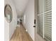 Long hallway with light walls, wood-look flooring, and a view into the living area at 237 Epping St # 89, Stockbridge, GA 30281