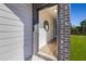 Front entryway with brick and siding, light wood floors, and a circular mirror at 237 Epping St # 89, Stockbridge, GA 30281