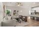 Open living room with light flooring, comfortable seating, and a view into the kitchen at 237 Epping St # 89, Stockbridge, GA 30281