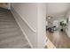 Carpeted staircase with a white railing leading to the upper level at 237 Epping St # 89, Stockbridge, GA 30281