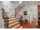 Grand staircase with wrought iron railings and hardwood steps at 4280 Kingston Gate Cv, Chamblee, GA 30341