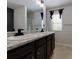 Double vanity bathroom with granite countertops and large mirror at 4505 Ravenwood Dr, Union City, GA 30291