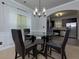 Dining room with glass table and kitchen view at 4505 Ravenwood Dr, Union City, GA 30291