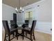 Dining room with glass table and four chairs at 4505 Ravenwood Dr, Union City, GA 30291
